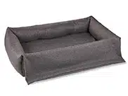 Weiches Hundebett für den Kofferraum mit ausklappbarem Stoßstangenschutz. Dunkelgrauer, robuster Outdoor-Stoff.